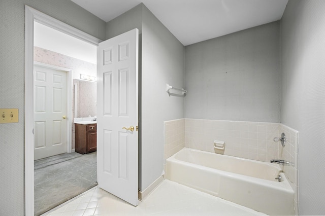 bathroom with vanity, a bathing tub, and tile patterned floors