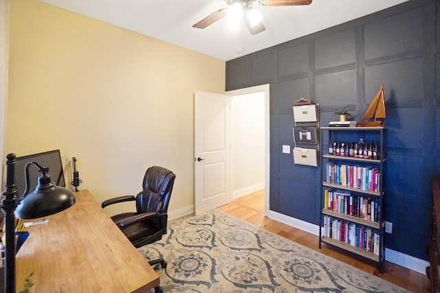 office space with hardwood / wood-style floors and ceiling fan