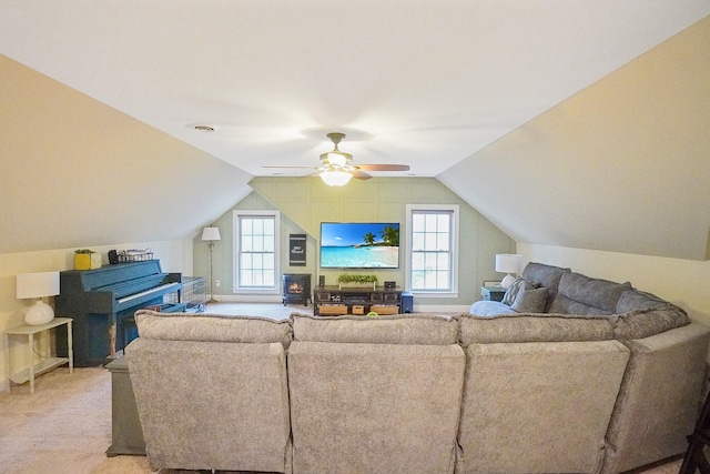 living room with ceiling fan, lofted ceiling, and carpet