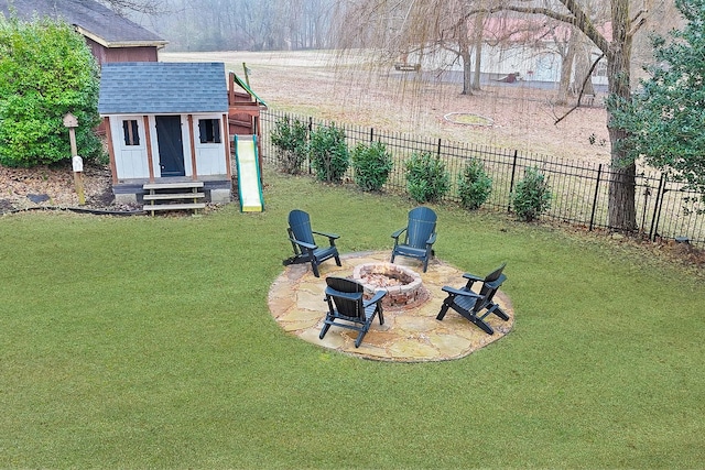 view of yard featuring a patio, a shed, and a fire pit