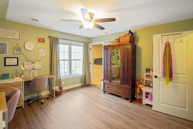 office featuring ceiling fan and light hardwood / wood-style flooring