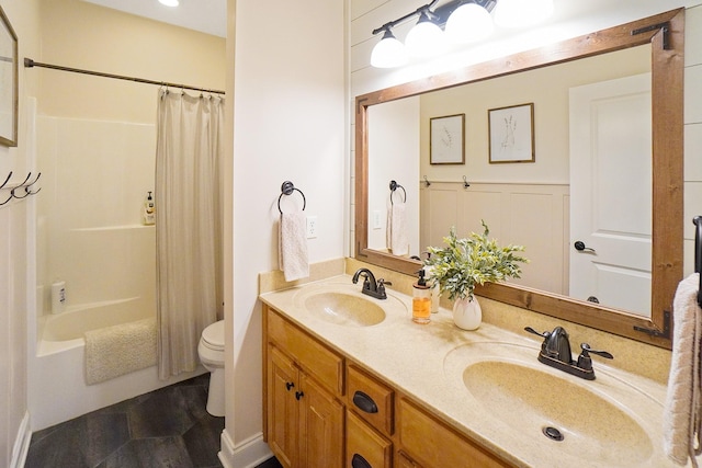 full bathroom with vanity, shower / tub combo with curtain, and toilet