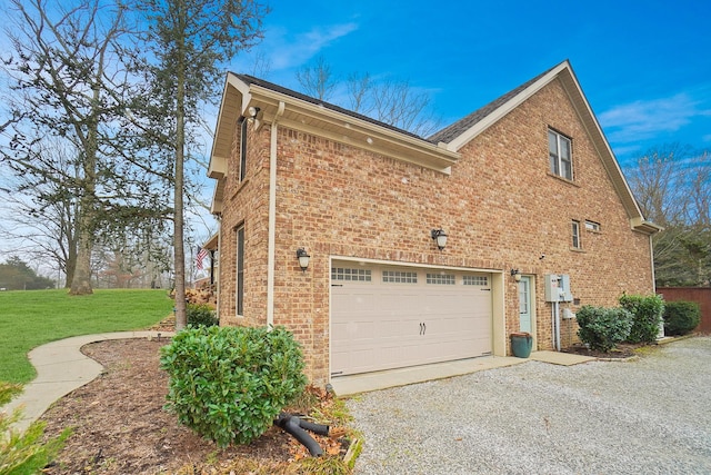 view of side of property featuring a garage and a lawn