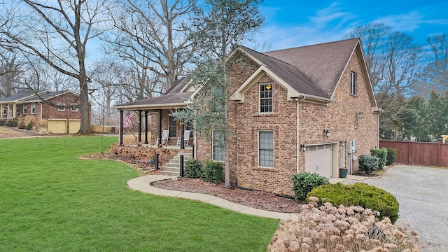 view of home's exterior featuring a porch, a garage, and a lawn