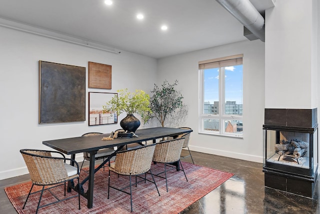 dining area featuring a multi sided fireplace