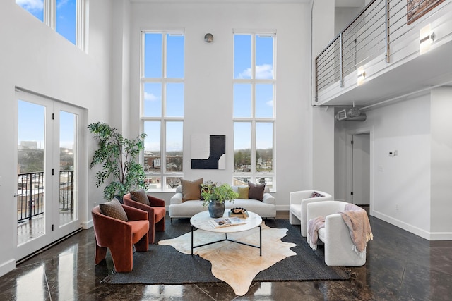 living room with a high ceiling and plenty of natural light