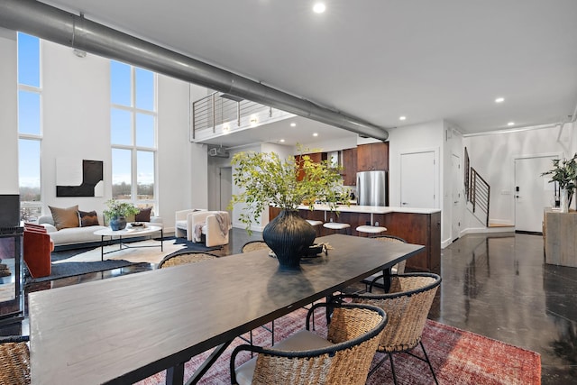 dining area with a towering ceiling