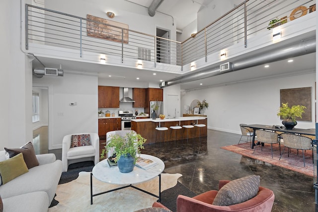 living room with sink and a towering ceiling