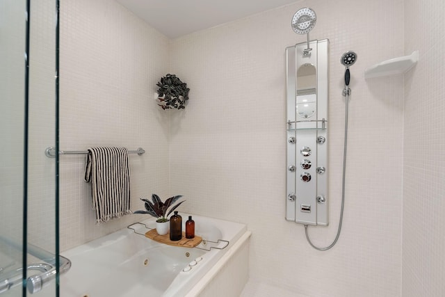 bathroom featuring tile walls and a washtub