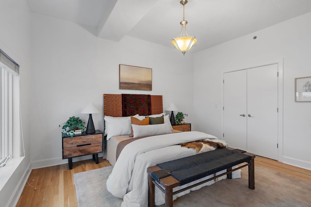 bedroom with a closet and light hardwood / wood-style flooring