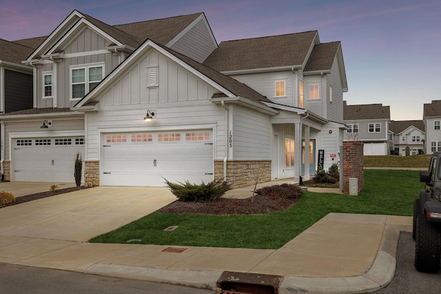 craftsman house featuring a garage and a lawn