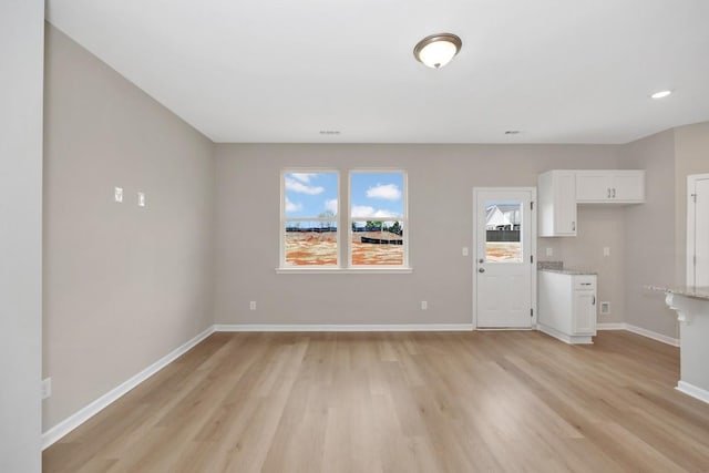 unfurnished living room with light hardwood / wood-style floors