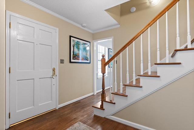 entryway featuring ornamental molding and dark hardwood / wood-style flooring