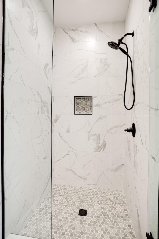 bathroom with tiled shower