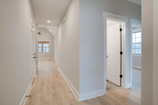 corridor with light hardwood / wood-style floors