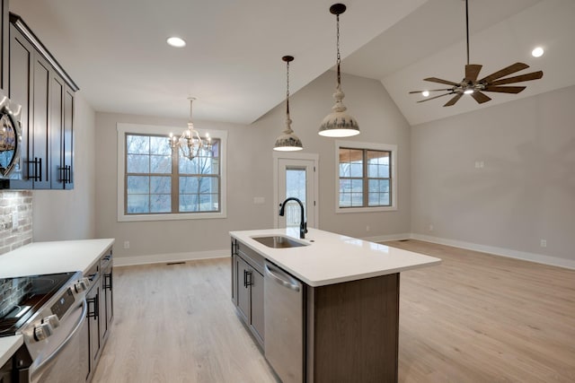 kitchen featuring a healthy amount of sunlight, appliances with stainless steel finishes, sink, and dark brown cabinetry