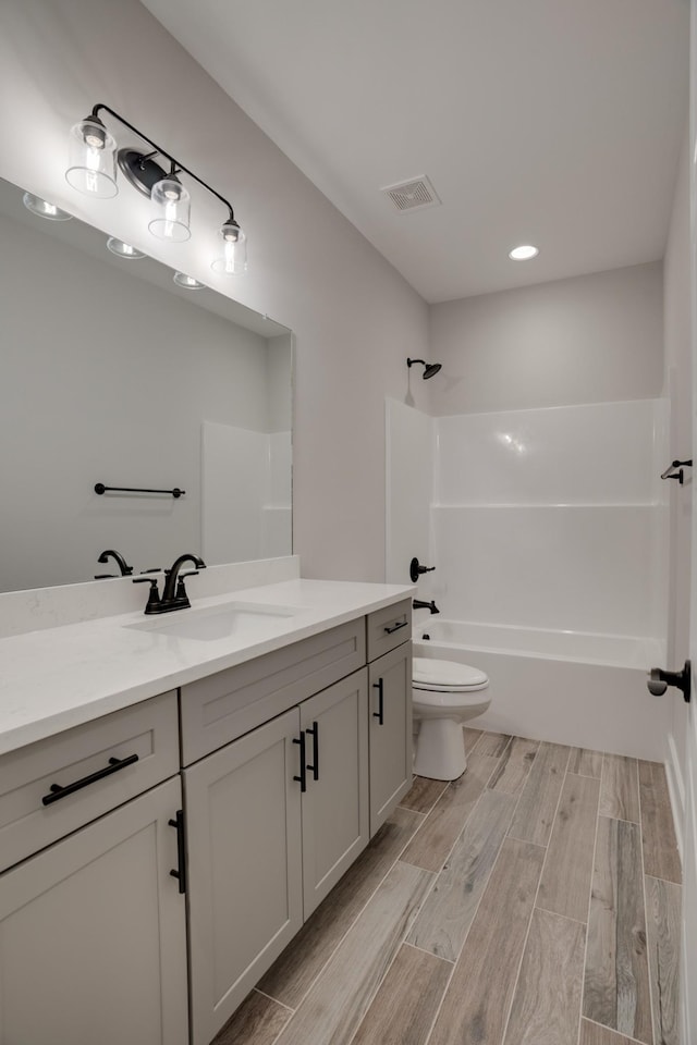 full bathroom featuring vanity,  shower combination, and toilet