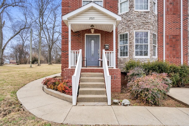 doorway to property featuring a yard