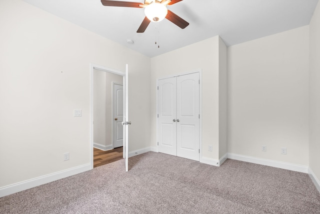 unfurnished bedroom with carpet floors, a closet, and ceiling fan