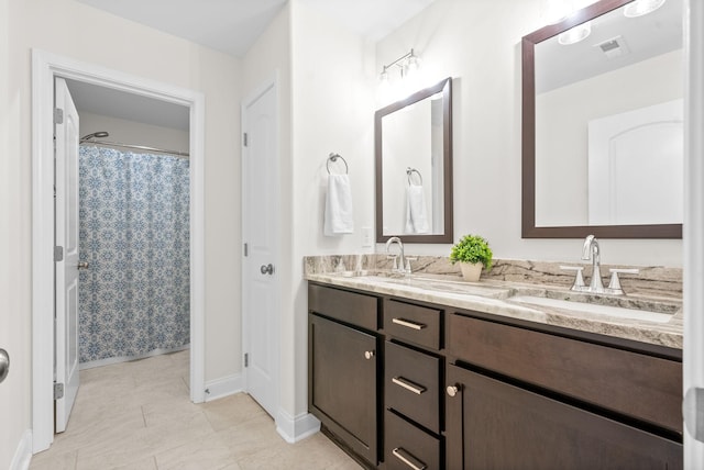 bathroom featuring vanity and curtained shower