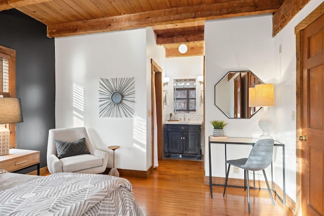 bedroom with sink, wood ceiling, ensuite bath, beamed ceiling, and light wood-type flooring