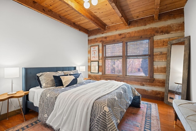 bedroom with hardwood / wood-style floors, wooden ceiling, and beamed ceiling