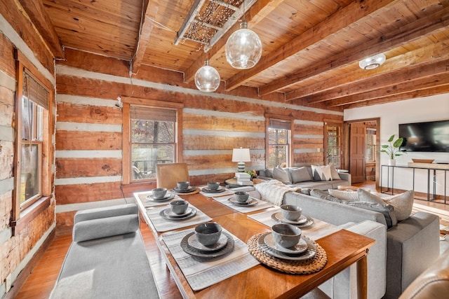 living room featuring hardwood / wood-style floors, wooden walls, wooden ceiling, and a healthy amount of sunlight