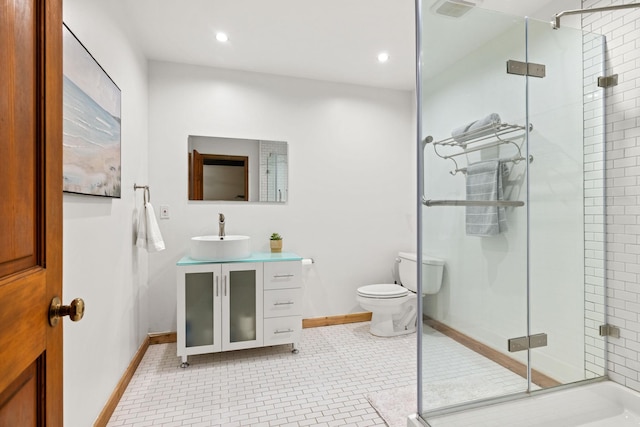 bathroom with vanity, toilet, a shower with shower door, and tile patterned flooring