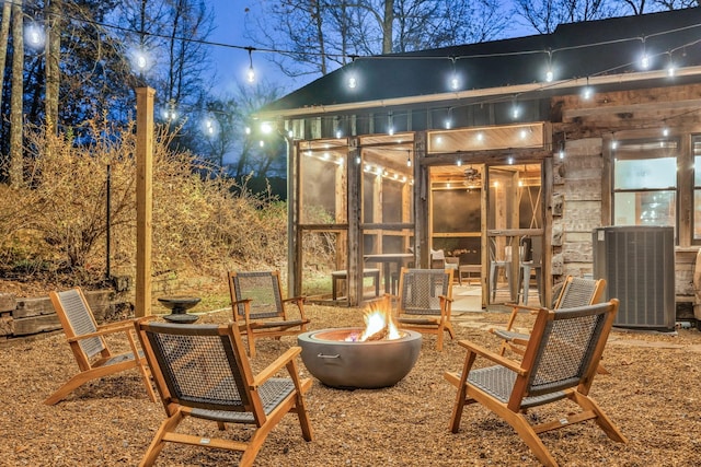 view of patio / terrace featuring cooling unit and an outdoor fire pit