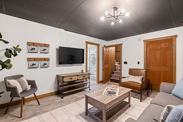 living room with hardwood / wood-style flooring and a chandelier