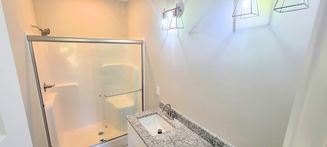 bathroom with walk in shower and vanity