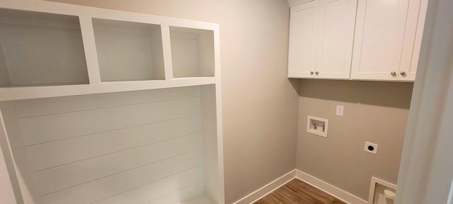 washroom featuring cabinets, hookup for a washing machine, dark hardwood / wood-style floors, and hookup for an electric dryer