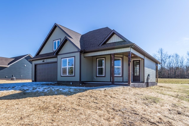 view of front of house featuring a garage and a porch