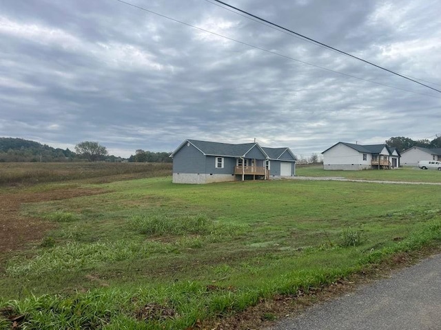 exterior space featuring a garage and a rural view