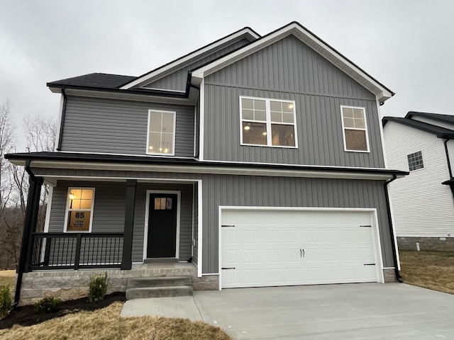 view of front of home with a porch and a garage