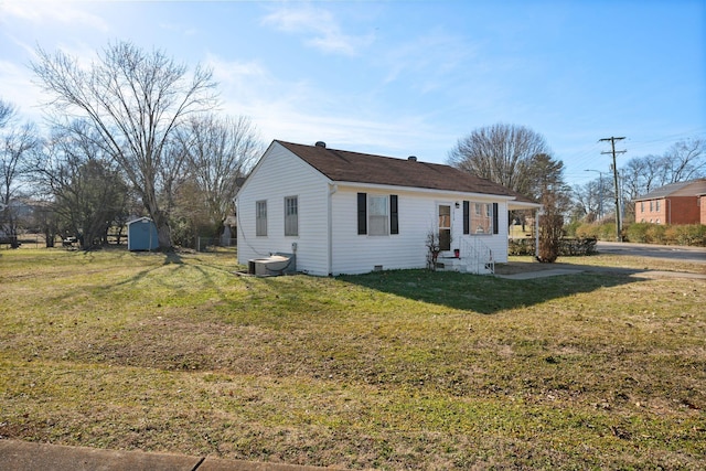 ranch-style home with a storage shed, central AC unit, and a front yard