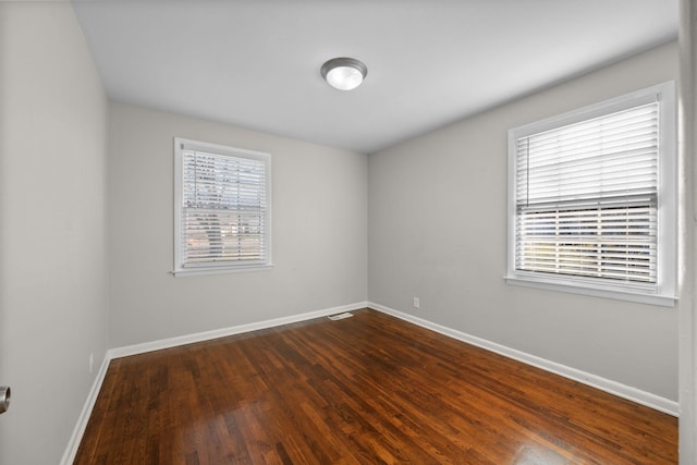 spare room featuring dark wood-type flooring