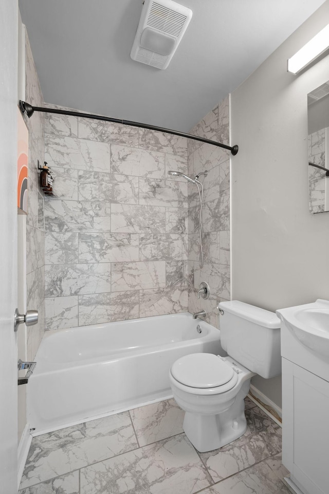 full bathroom with tiled shower / bath combo, vanity, and toilet