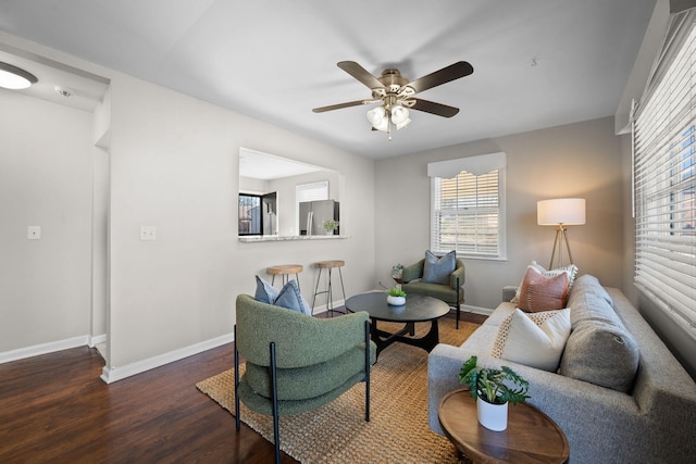 living room featuring dark hardwood / wood-style floors and ceiling fan