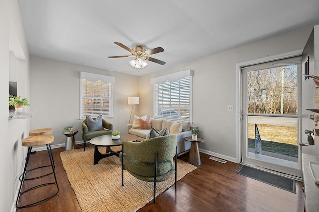 living room with ceiling fan and dark hardwood / wood-style flooring