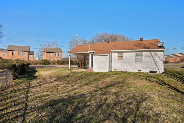 rear view of house with a patio and a lawn