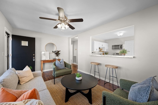 living room with hardwood / wood-style flooring and ceiling fan