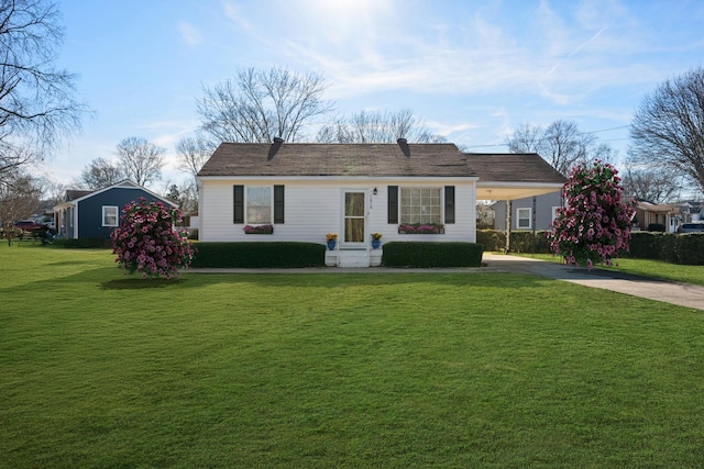 ranch-style house featuring a carport and a front lawn