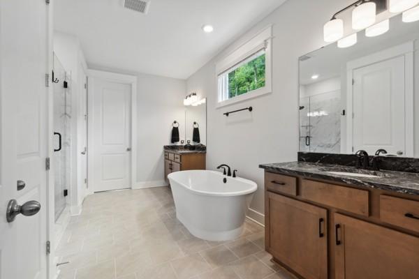 bathroom featuring vanity and separate shower and tub