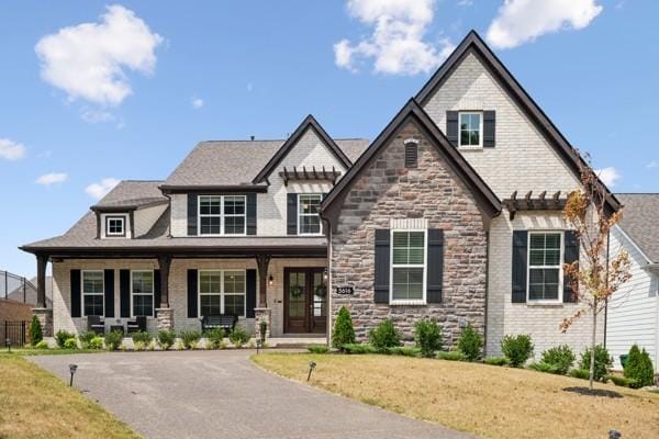 view of front of house featuring a porch and a front lawn