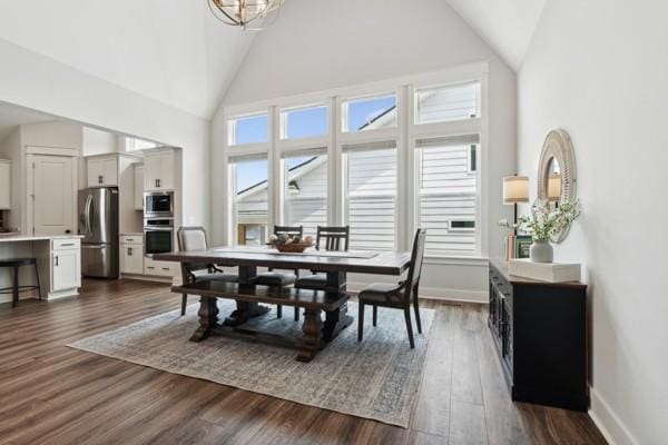 dining area with dark hardwood / wood-style floors and high vaulted ceiling