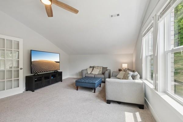 living room featuring lofted ceiling, light carpet, and ceiling fan