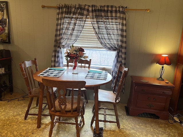 dining room with wooden walls