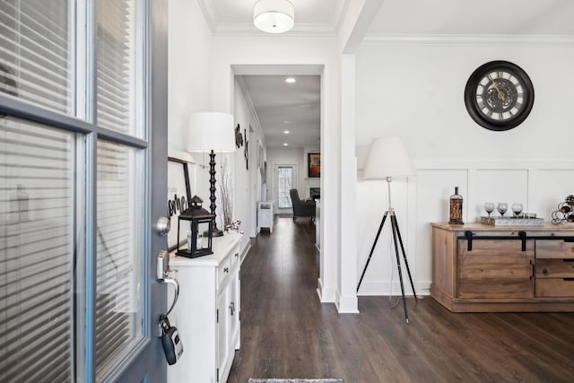 entryway with crown molding and dark hardwood / wood-style floors