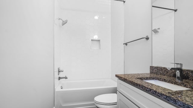 full bathroom with vanity, tiled shower / bath, and toilet